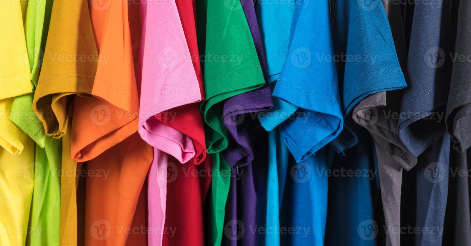 Colorful t-shirts hanging on a rack photo