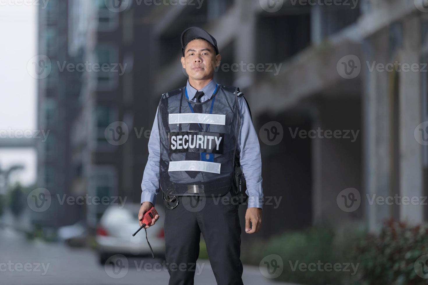 Male security guard using portable radio photo