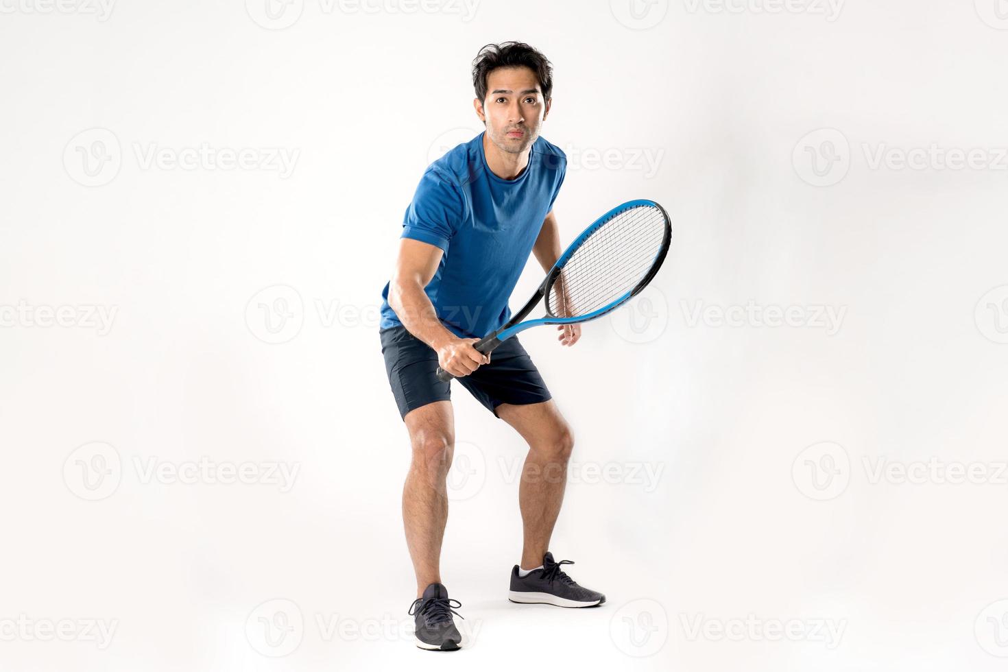 Male tennis player playing tennis with striving for victory gesture. photo