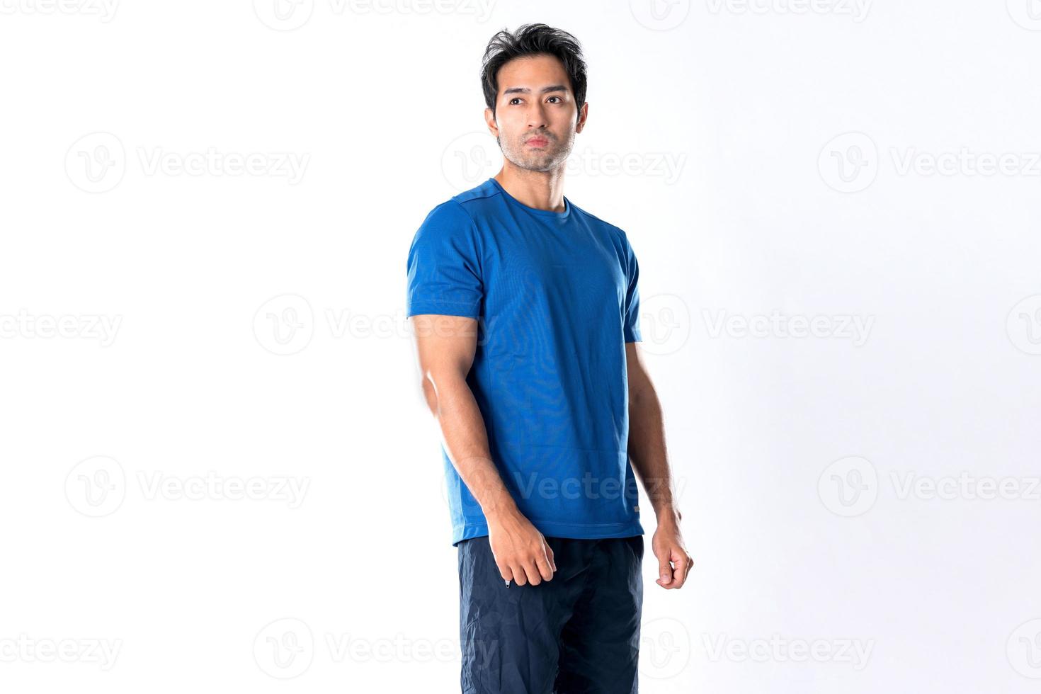 Elegant young man in blue shirt standing on white background photo