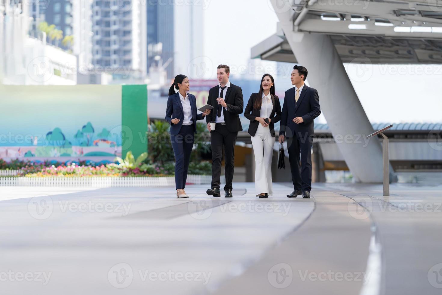 Business people walking and talk to each other in front of modern office photo