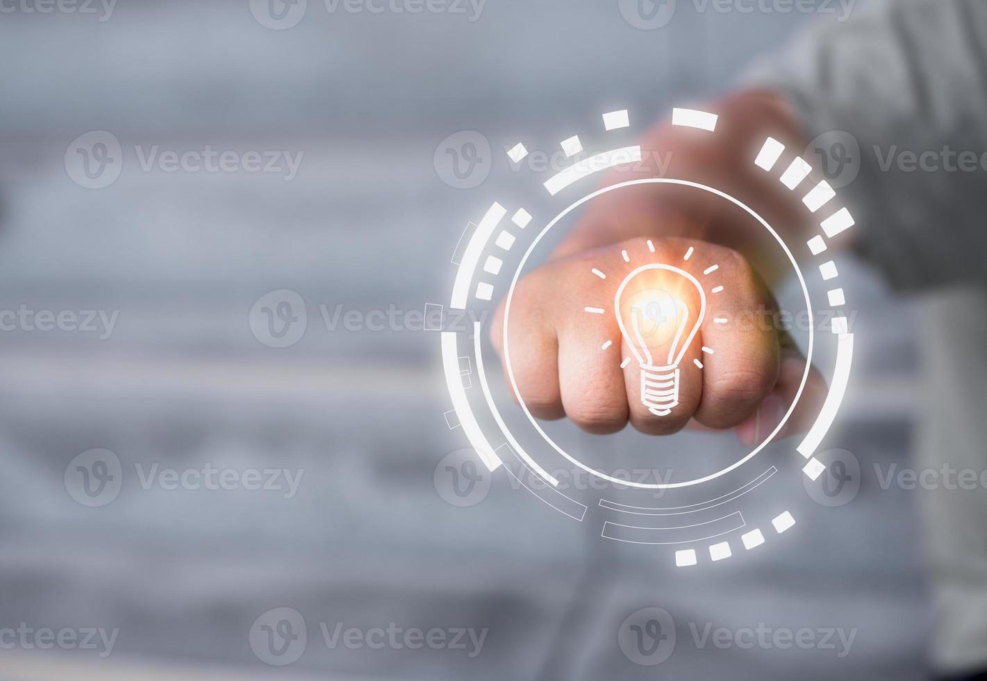 creative new ideas concept, a man clenched a fist hitting virtual light bulb in concept of thinking an ideas. photo