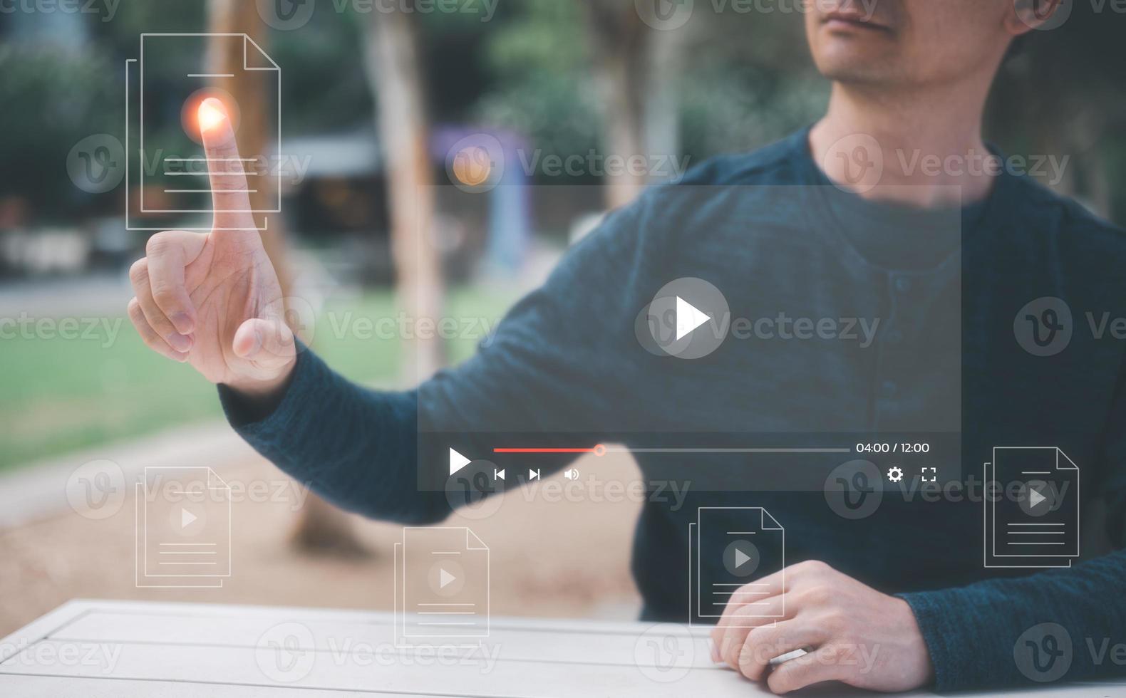 entertainment life style man sitting outdoor using  internet for streaming online, watching video on internet, live concert, show or tutorial photo