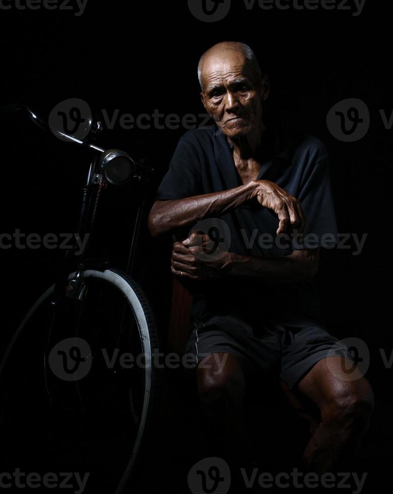 Old man with his bicycle photo