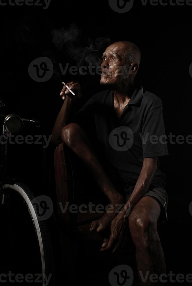 Old man with his bicycle photo