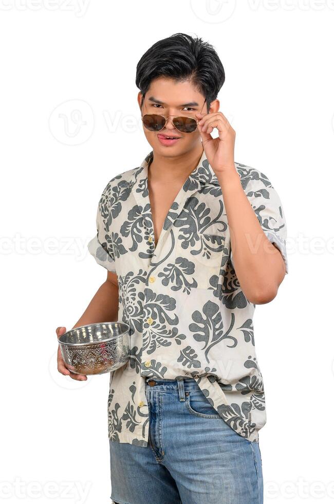 Portrait young man with water bowl in Songkran Festival photo