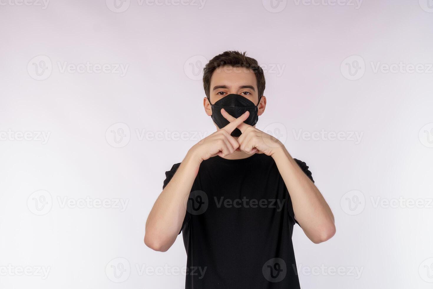 Portrait of young handsome man wearing medical mask doing stop sing with palm of the hand over white background photo