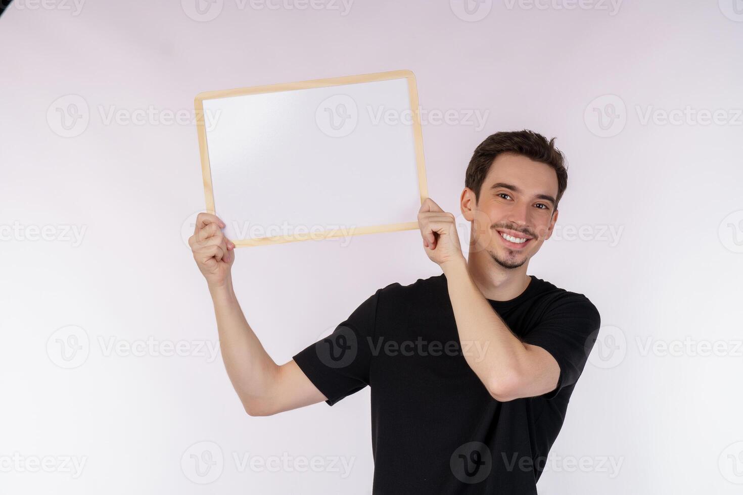 Portrait of happy man showing blank signboard on isolated white background photo