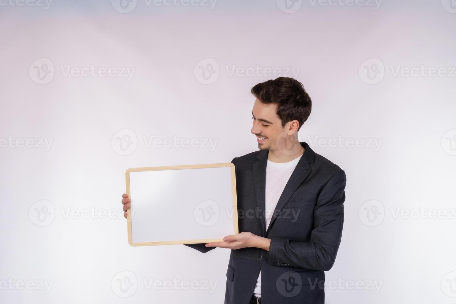 Portrait of happy businessman showing blank signboard on isolated white background photo