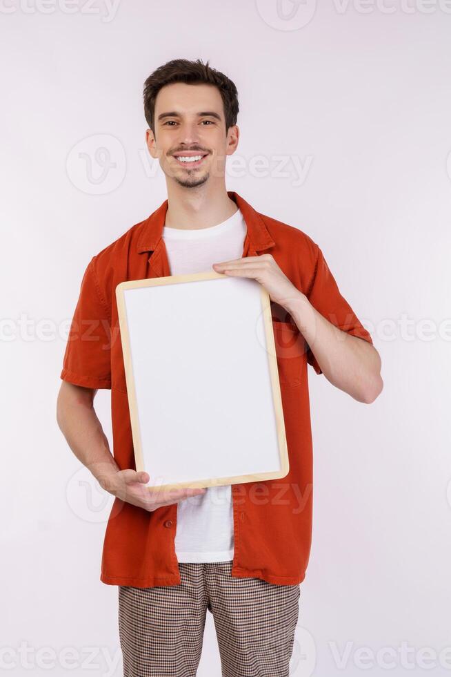 Portrait of happy man showing blank signboard on isolated white background photo