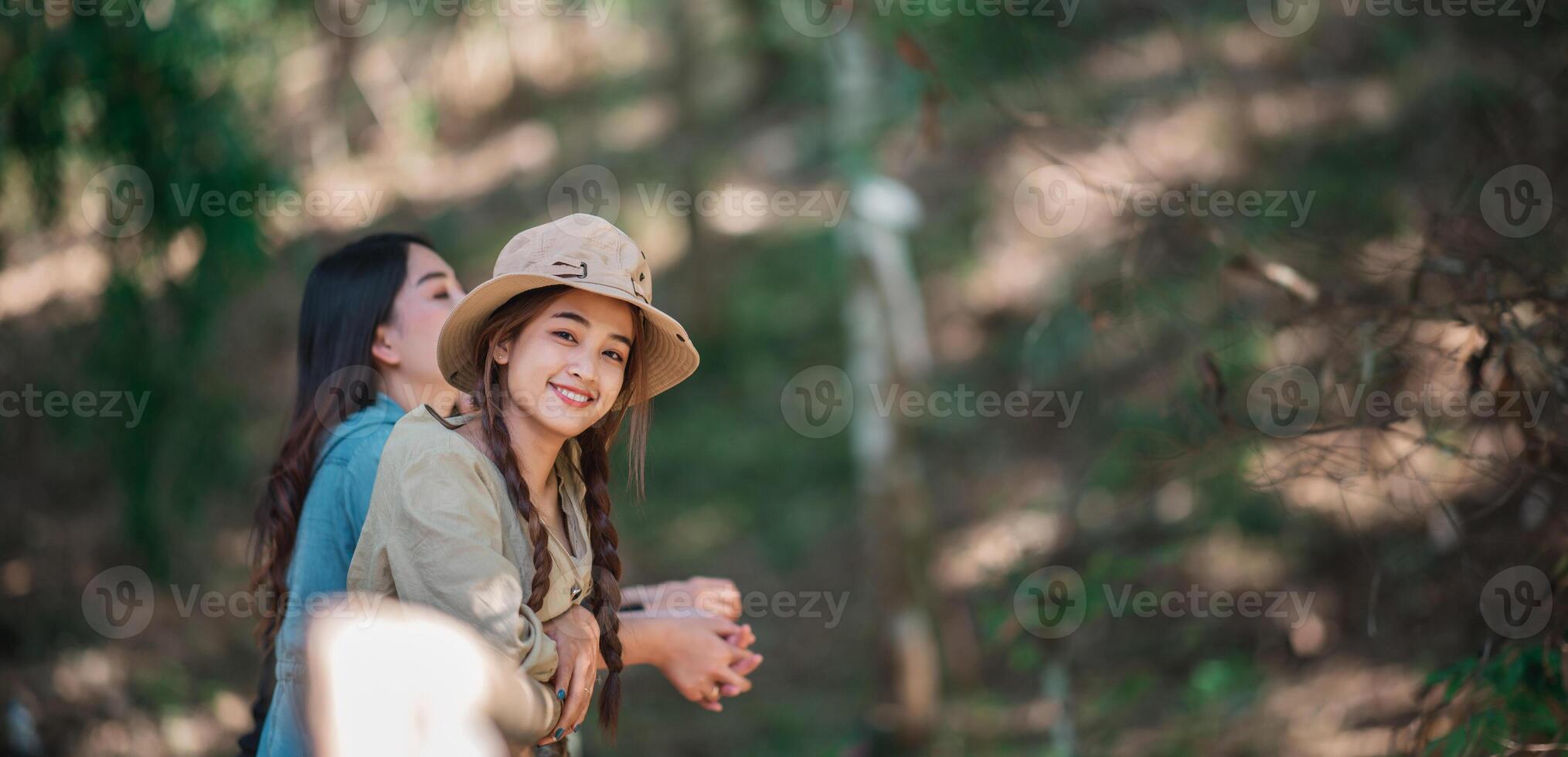 group  young women looking beautiful nature while camping in forest photo