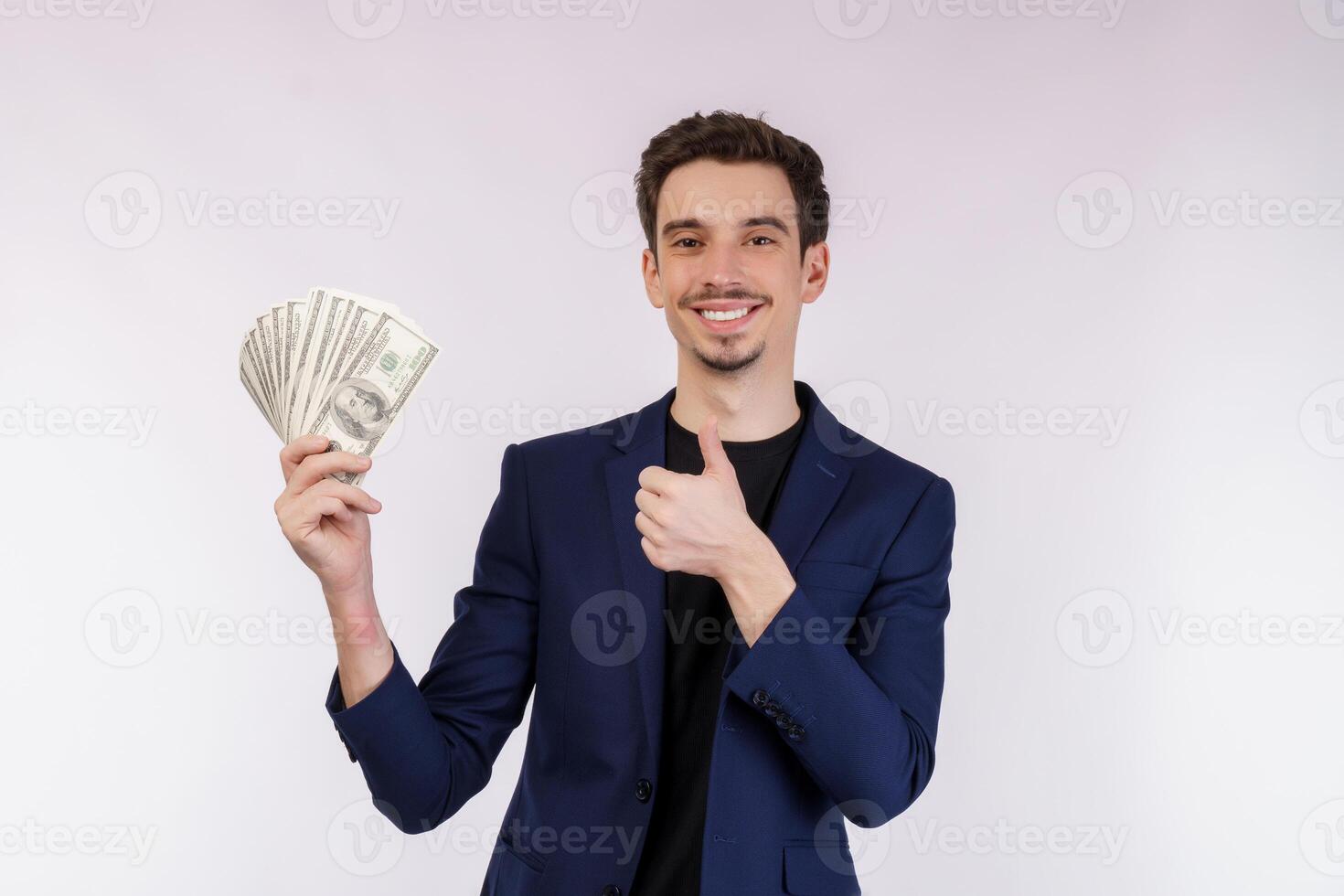 Portrait of a cheerful man holding dollar bills over white background photo