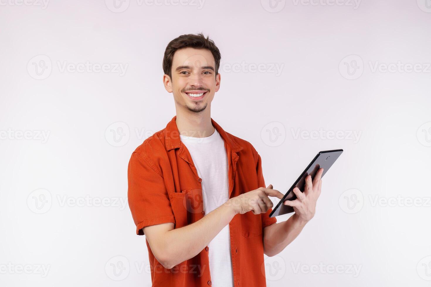Portrait of attractive cheerful man using device app searching web isolated over white color background photo