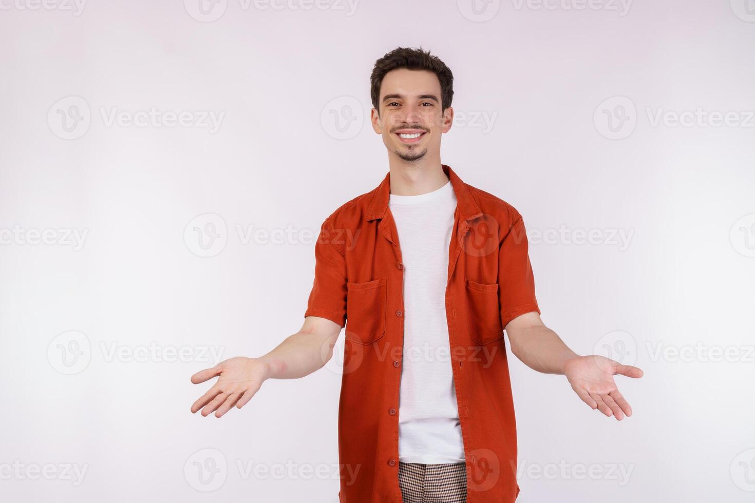 Portrait of puzzled clueless young man arms out asking why what's the problem who cares so what, I don't know photo