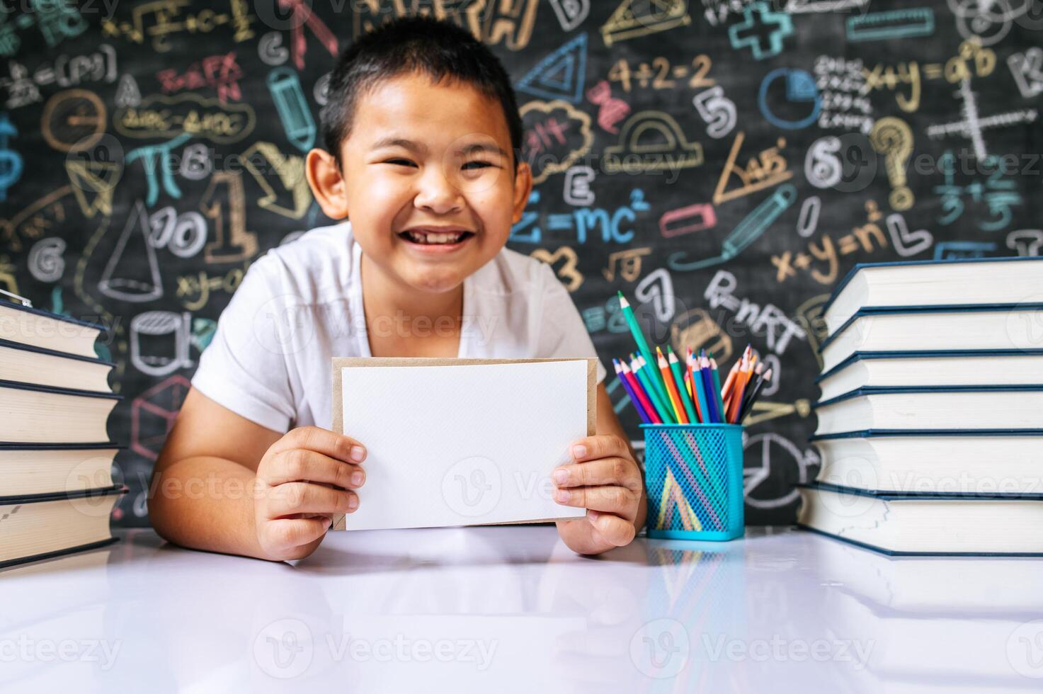 Child acting with envenlope in the classroom photo