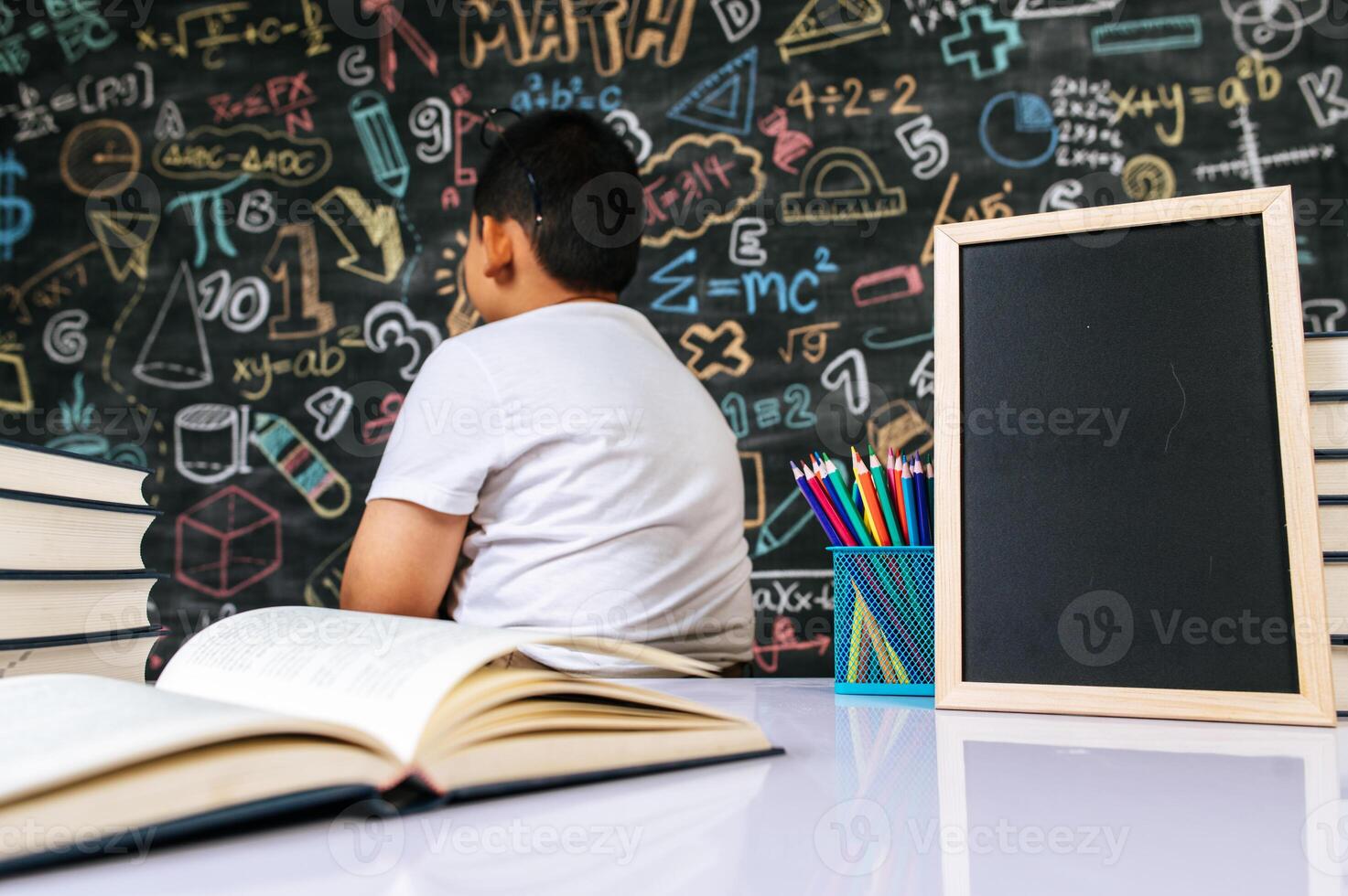 child sit with back in the classroom photo