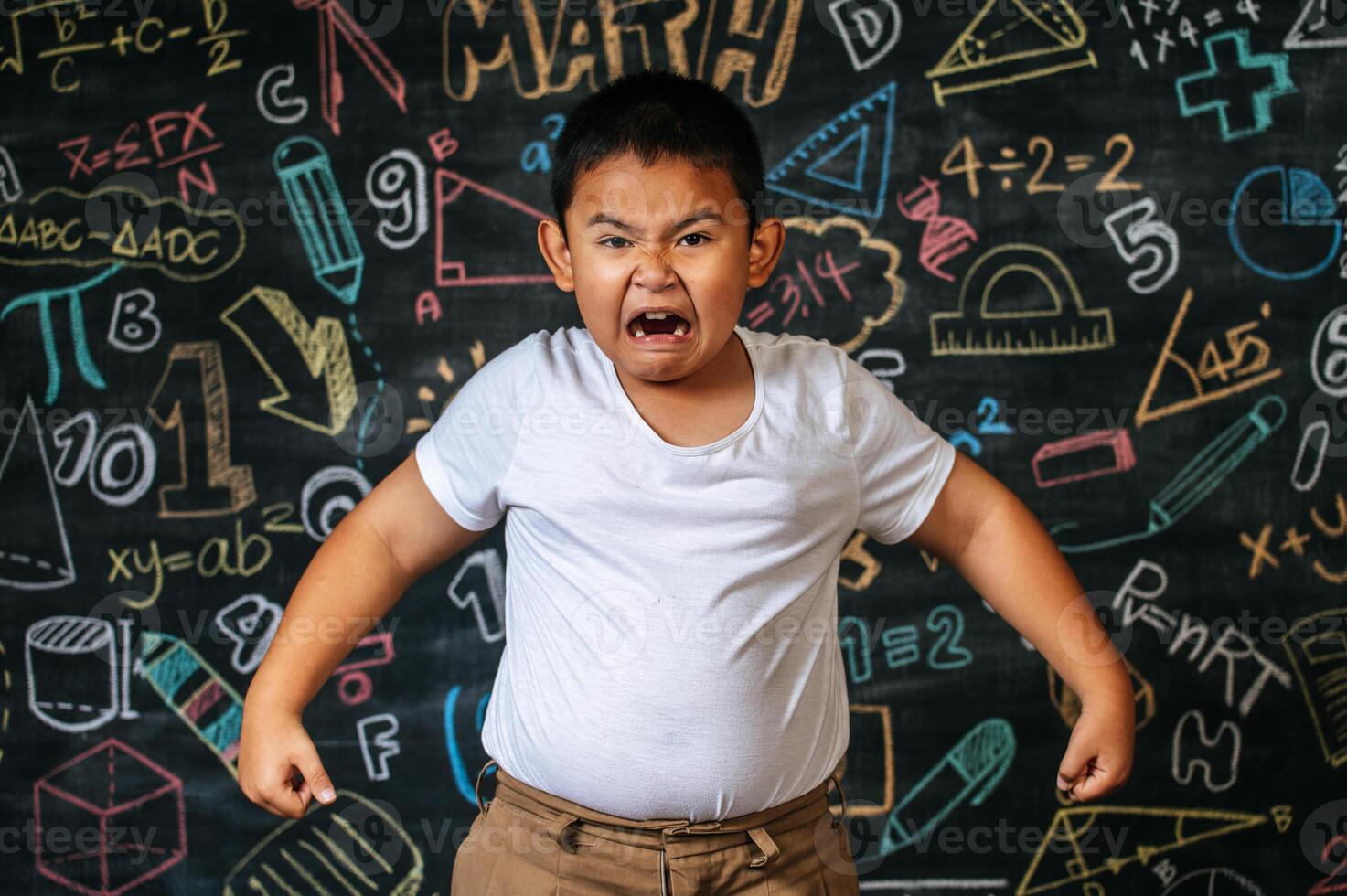 Child standing and acting in the classroom photo