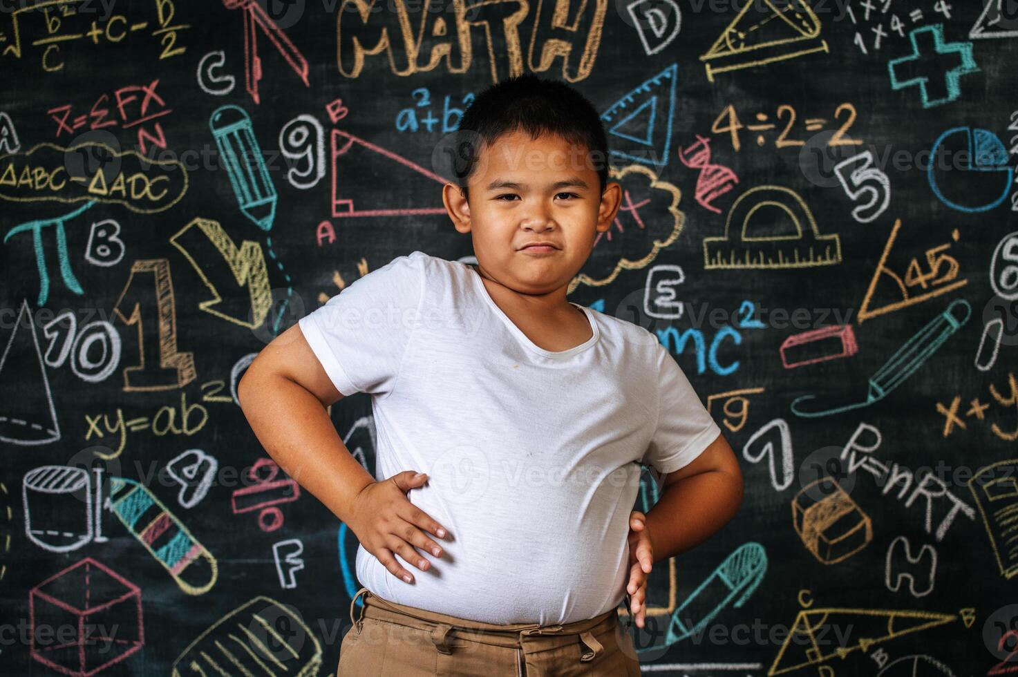 Child standing and acting in the classroom photo