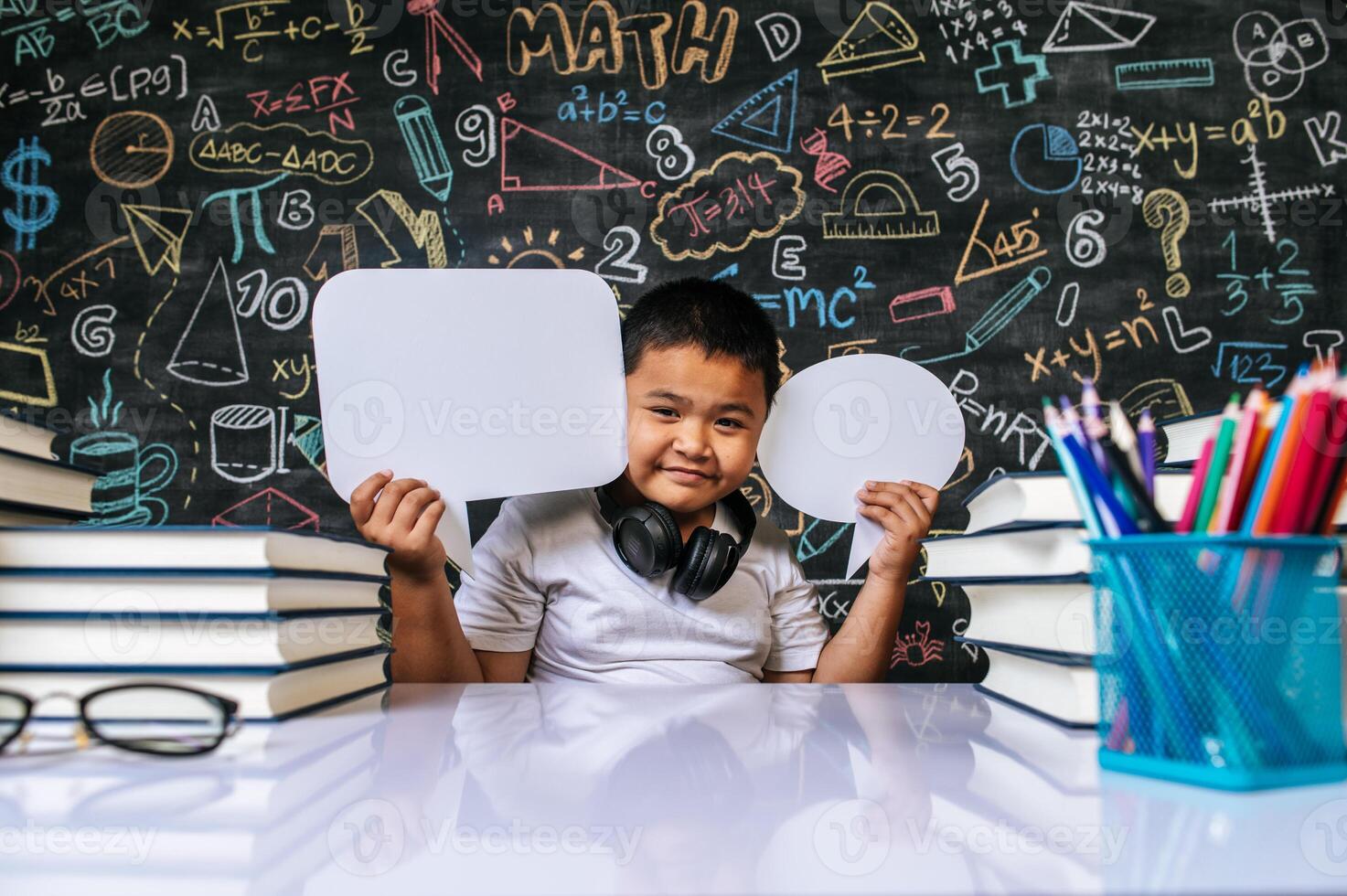 Child acting with speech bubble in the classroom photo