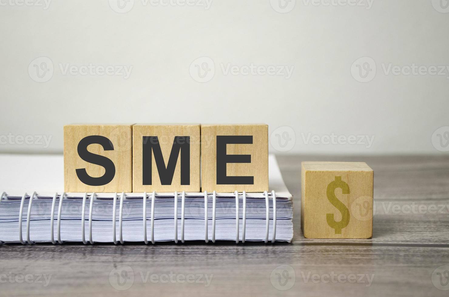 sme text from wooden blocks on a grey wooden background photo