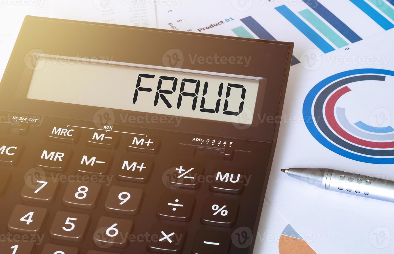 Word fraud on calculator. Business and finance concept. photo