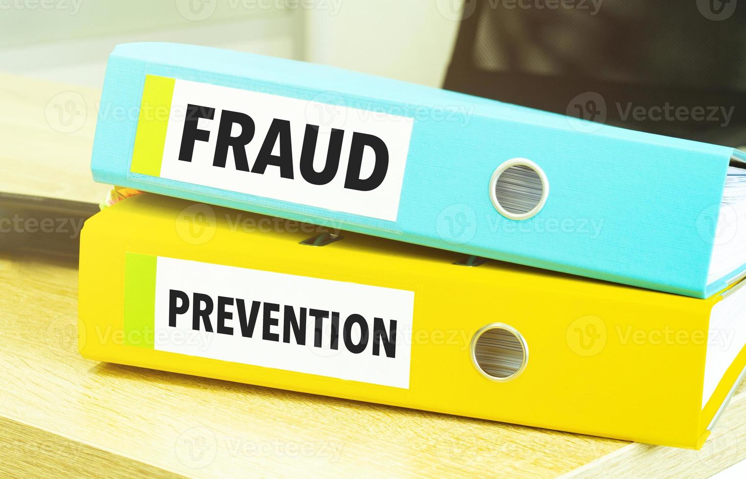 fraud prevention on colourful folders on table photo