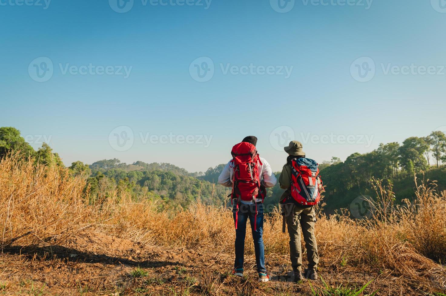 traveler couple with backpack standing looking view on mountain photo