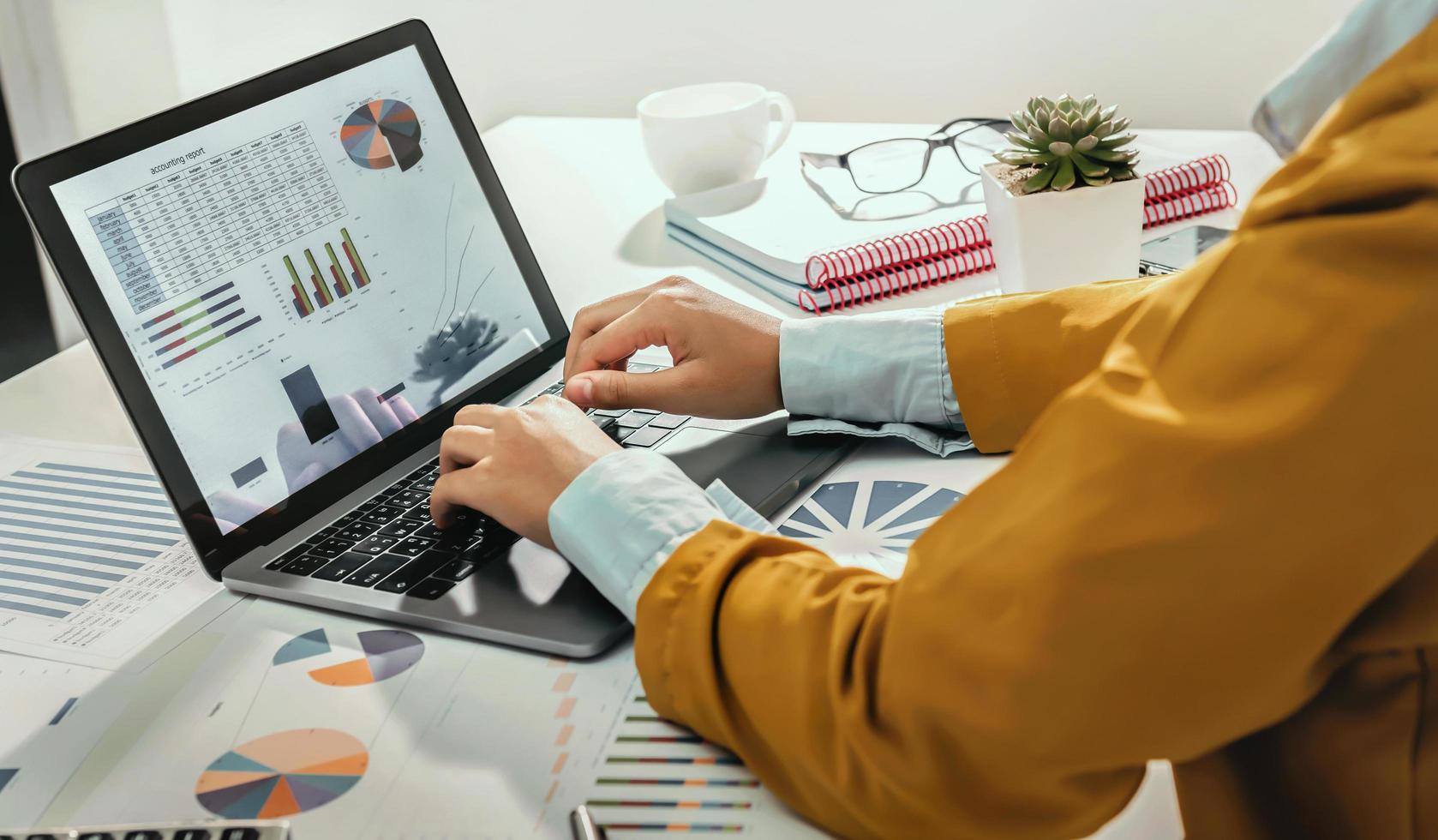 accounting concept. businesswoman working using calculator with money stack in office photo