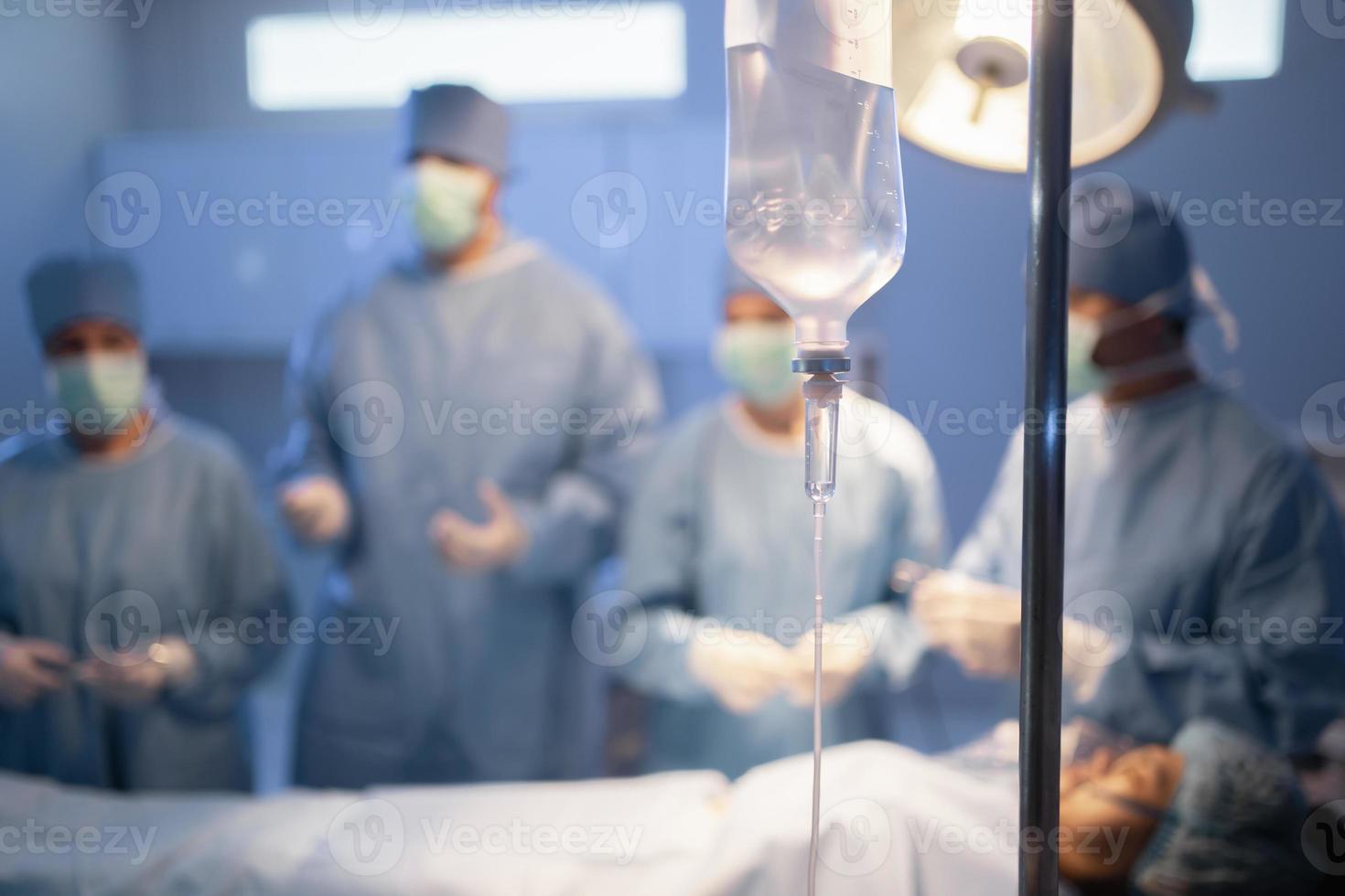 selective focus of intravenous dripmedicine  blur background of medical workers photo
