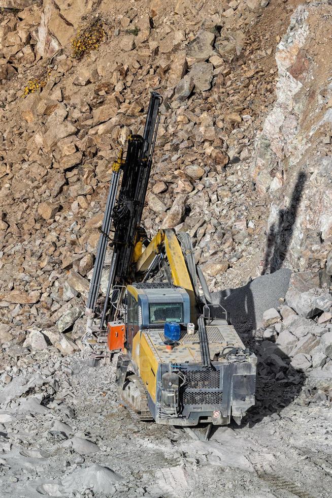 Drilling machine in open cast mining quarry photo