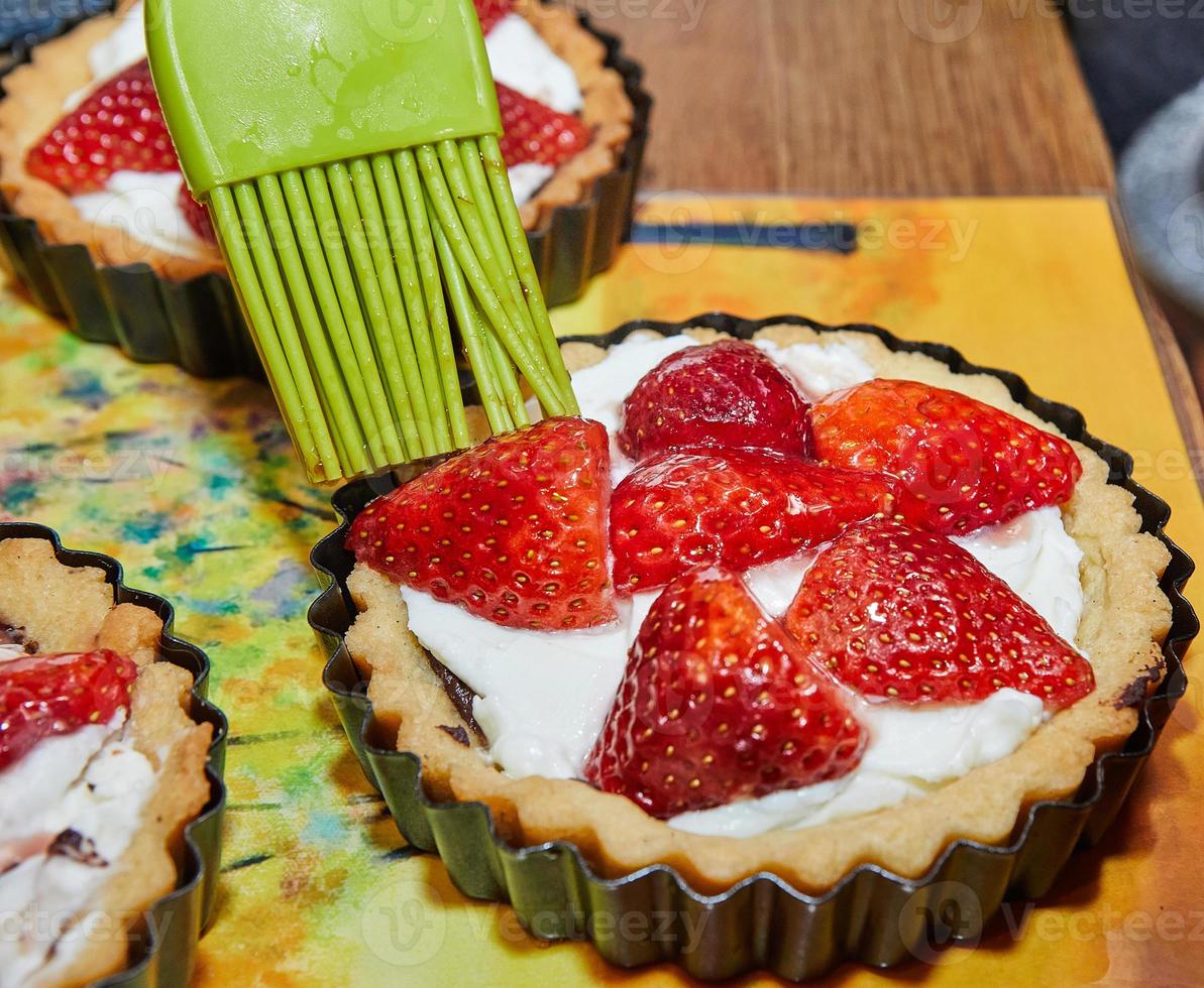 Manufacturing process Round cream pie with chocolate and strawberries. French recipe photo