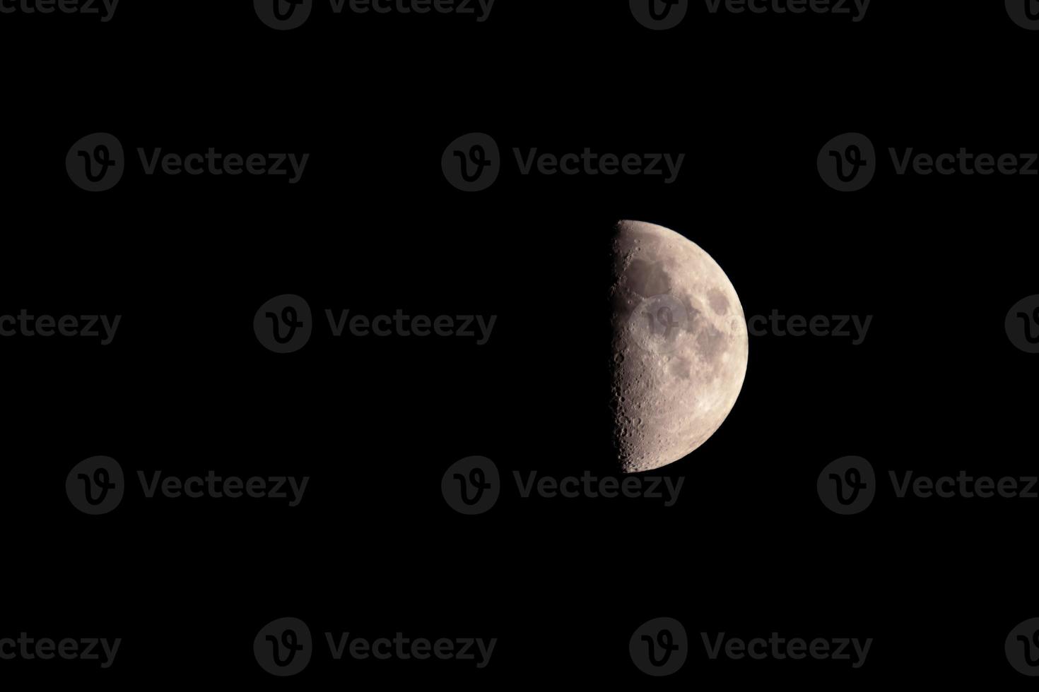 a lunar eclipse the moon is half visible,the background is black photo