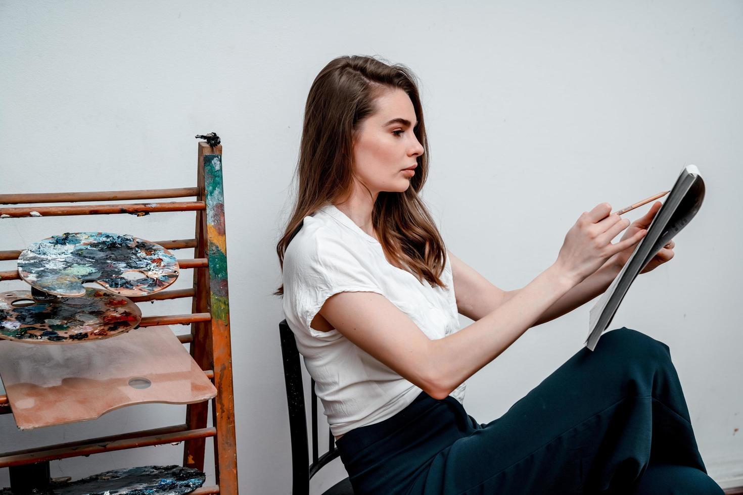 Young artist working on a painting in a cozy studio photo