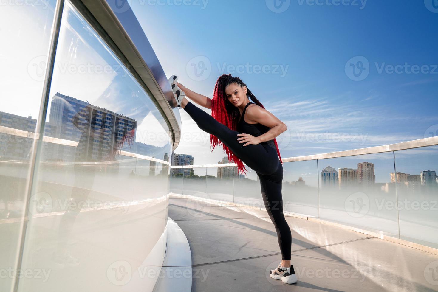 Fitness, exercise and a woman stretching at gym during warm up workout and training for health and wellness. Sports female or athlete on ground to stretch legs to be flexible, balance and healthy photo