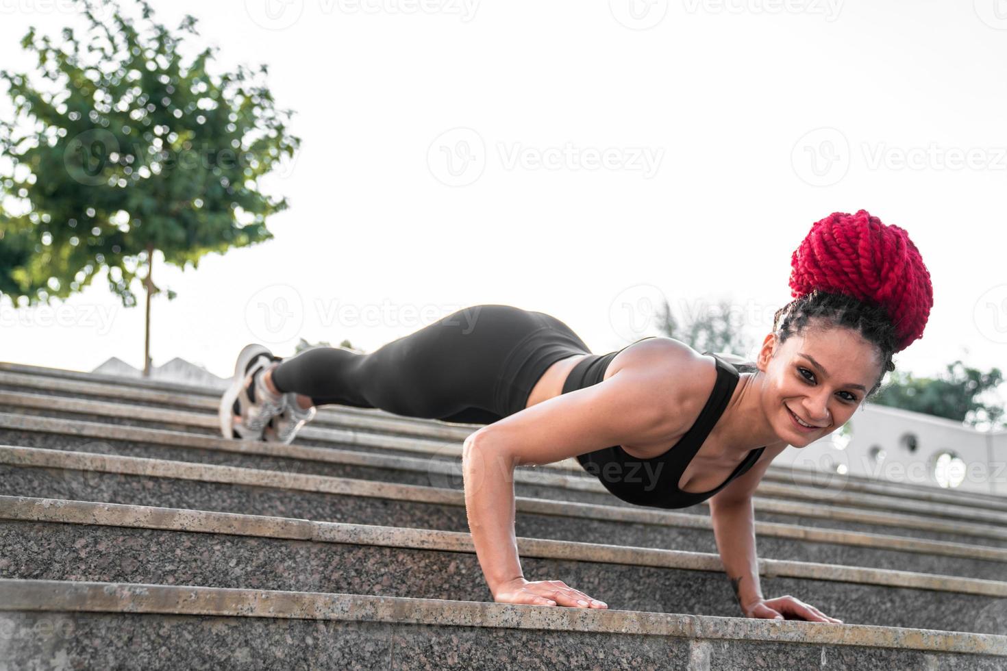 Fitness, gym and workout of a woman doing plank exercise or training for wellness with focus for healthy lifestyle. Female athlete with body weight routine for strong core, sports health and balance photo