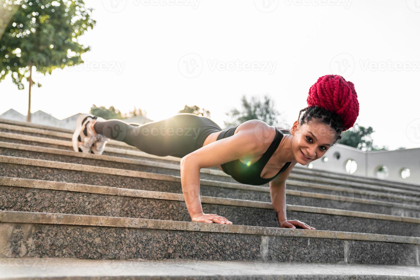 Fitness, gym and workout of a woman doing plank exercise or training for wellness with focus for healthy lifestyle. Female athlete with body weight routine for strong core, sports health and balance photo