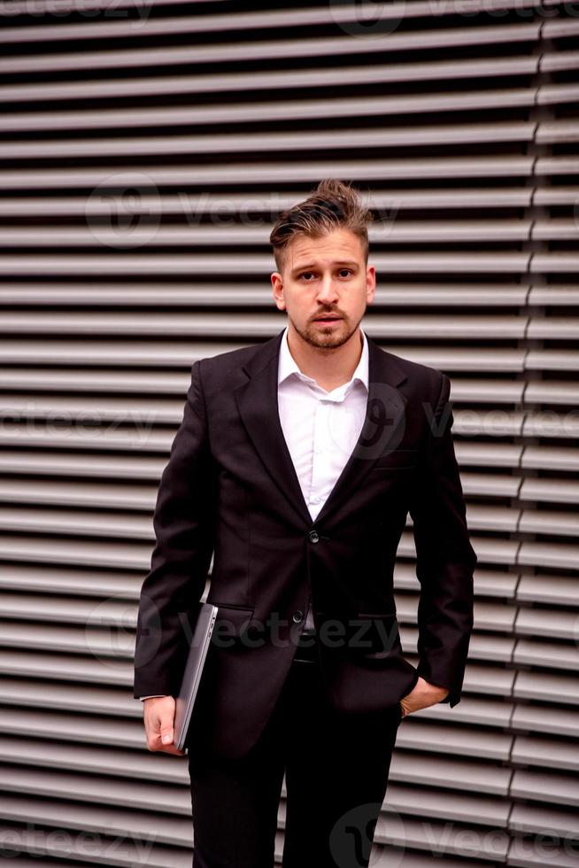 Portrait of a young businessman in a business center photo