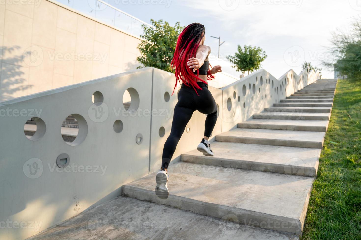 Fit young woman jumping and running photo