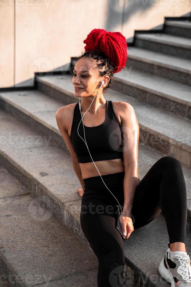 a woman in a sports bra and shorts is doing yoga on the beach 31417230  Stock Photo at Vecteezy