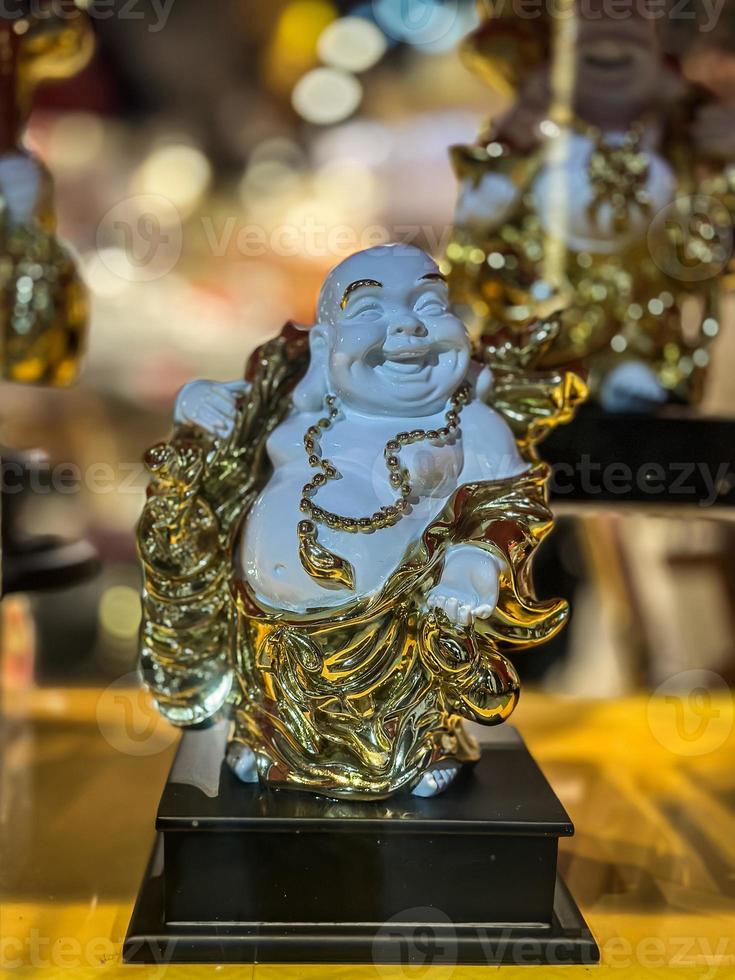 White and gold statue of lucky baba photo