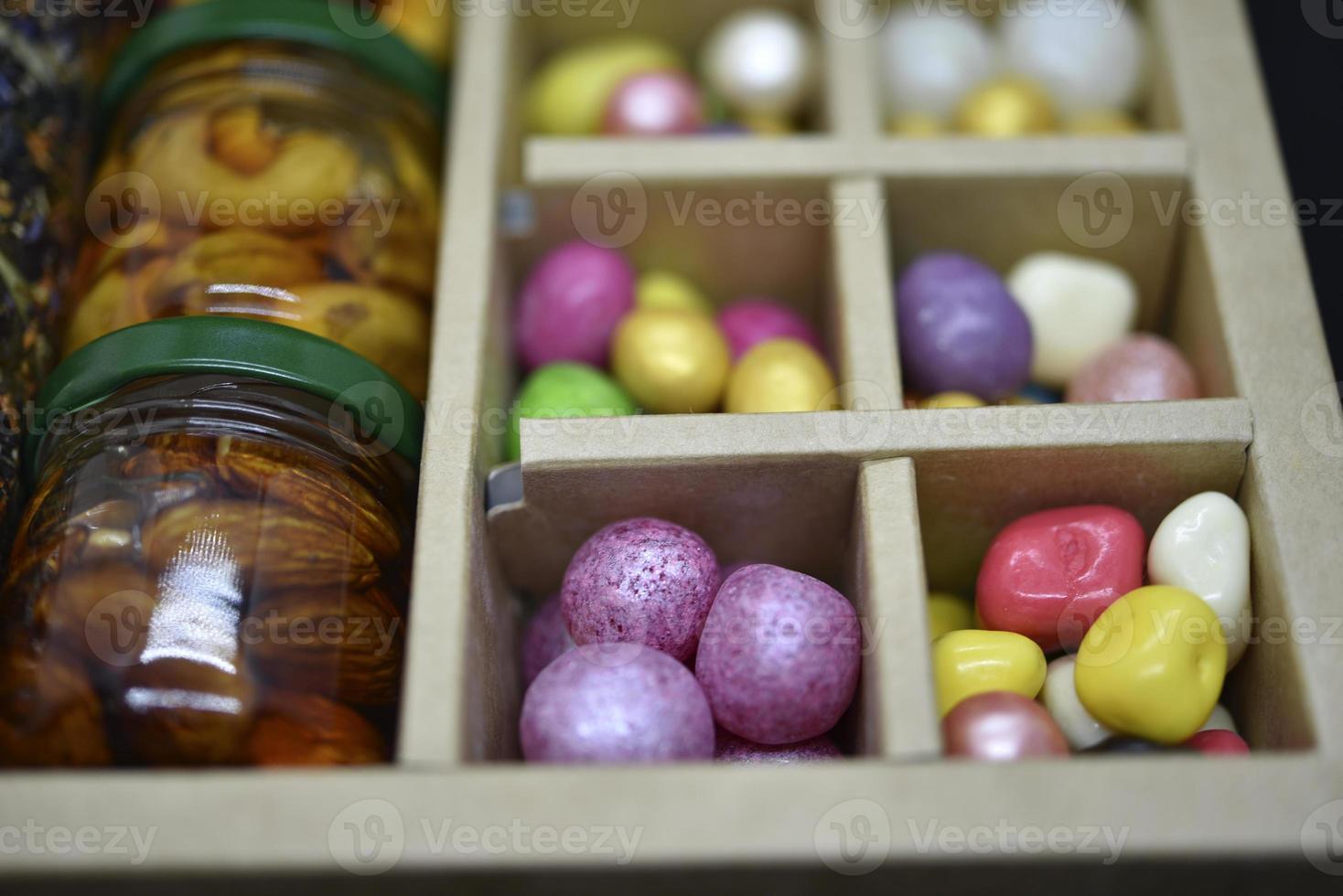 A gift set of sweets and nuts in honey. Delicious sweets. Colorful sweets. photo