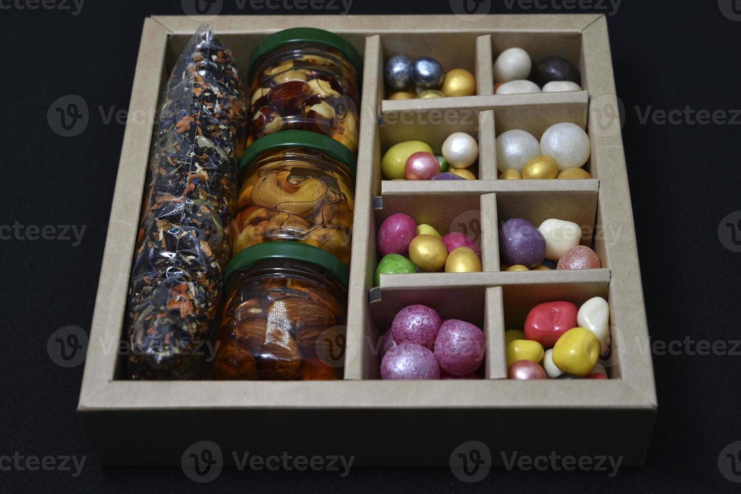 A gift set of sweets and nuts in honey. Delicious sweets. Colorful sweets. photo