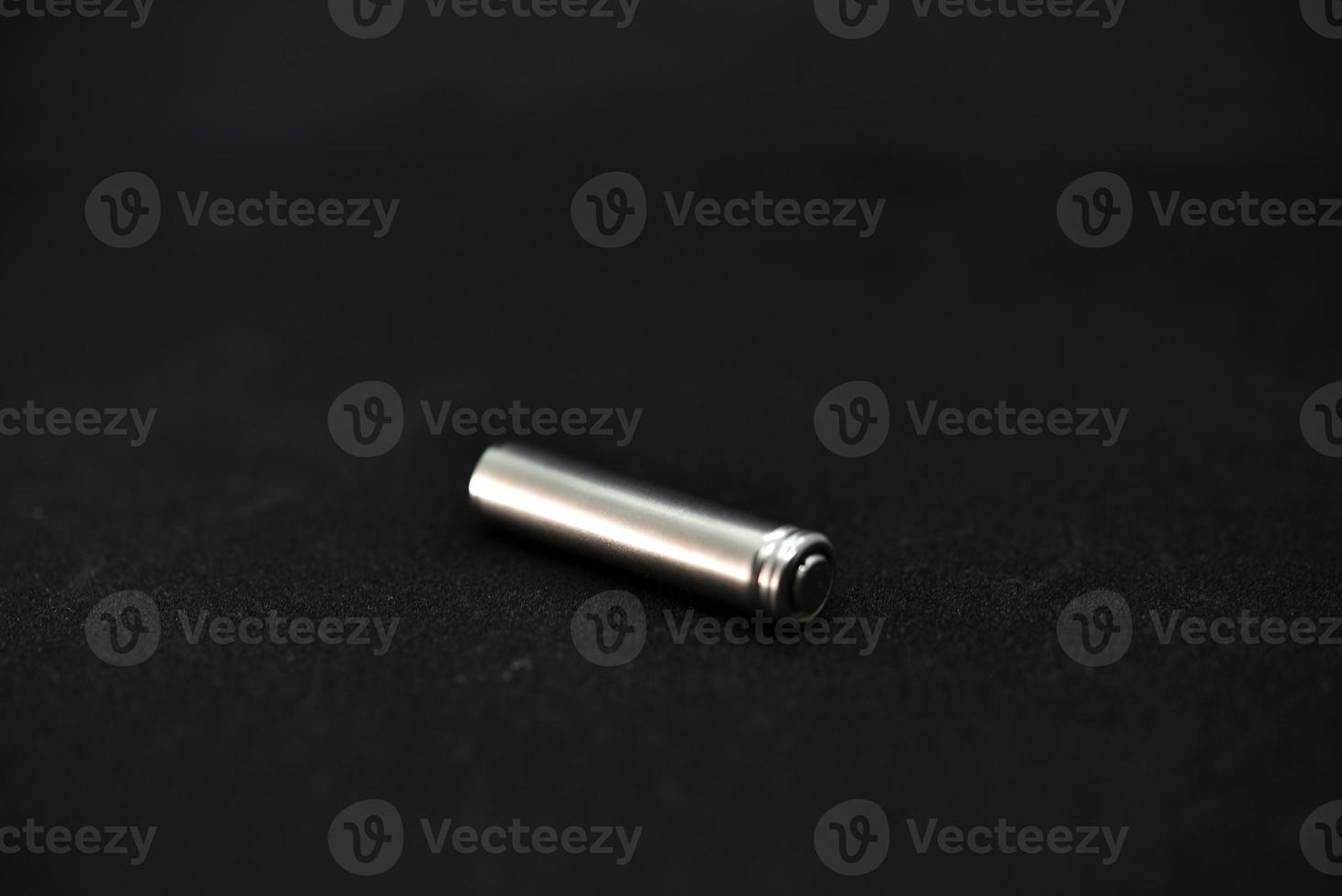 A shiny electric battery on a black background. The battery is a close-up. photo