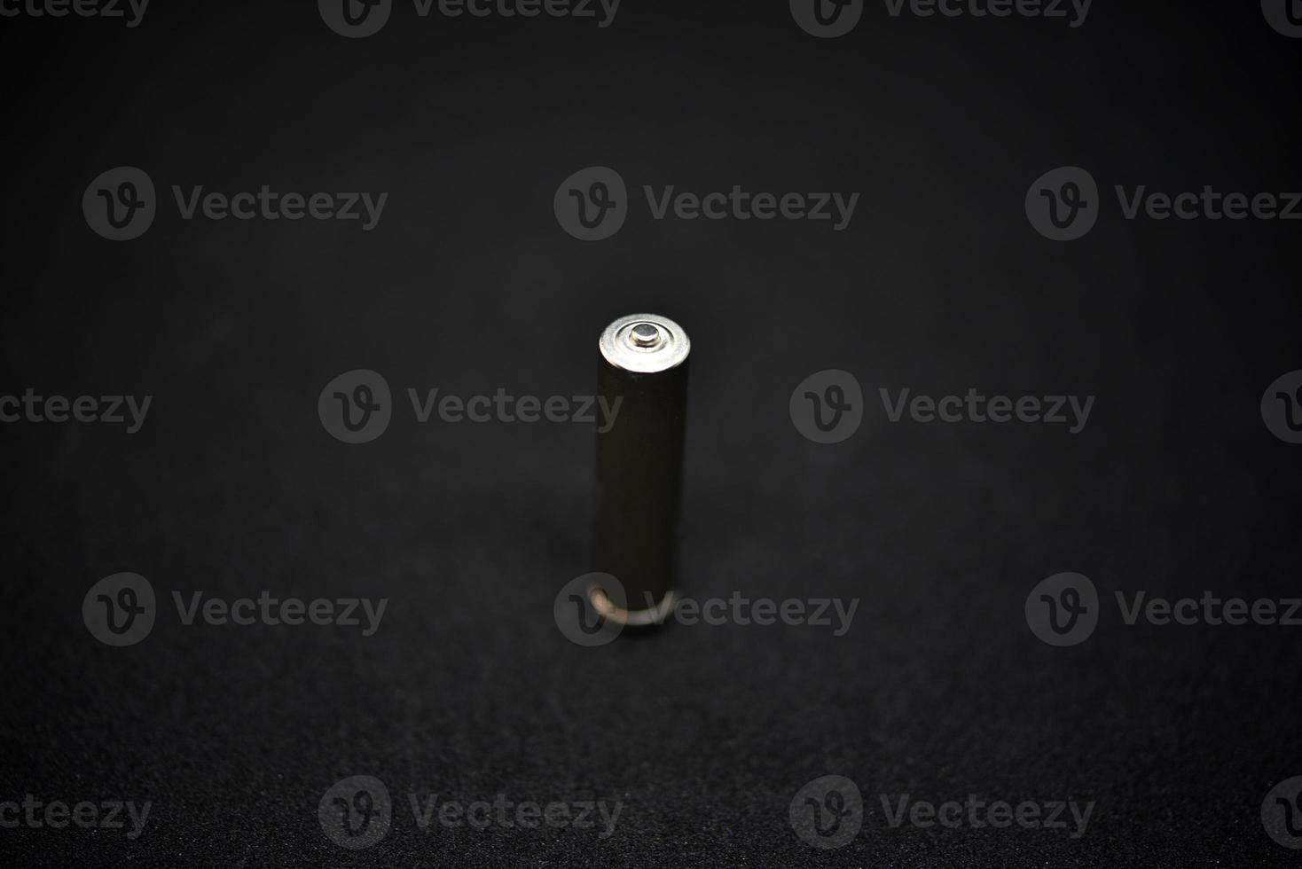 A shiny electric battery on a black background. The battery is a close-up. photo