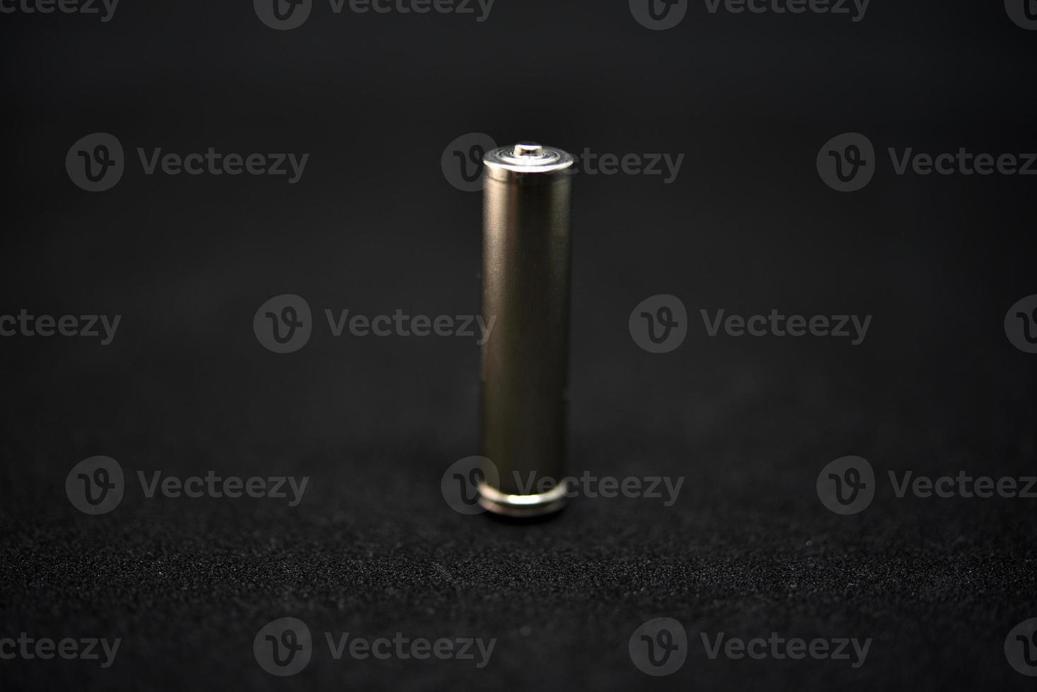 A shiny electric battery on a black background. The battery is a close-up. photo