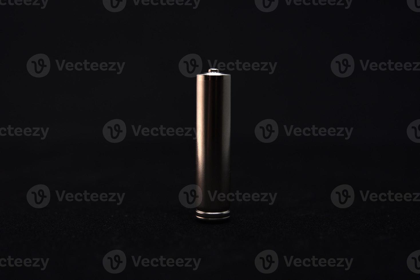 A shiny electric battery on a black background. The battery is a close-up. photo