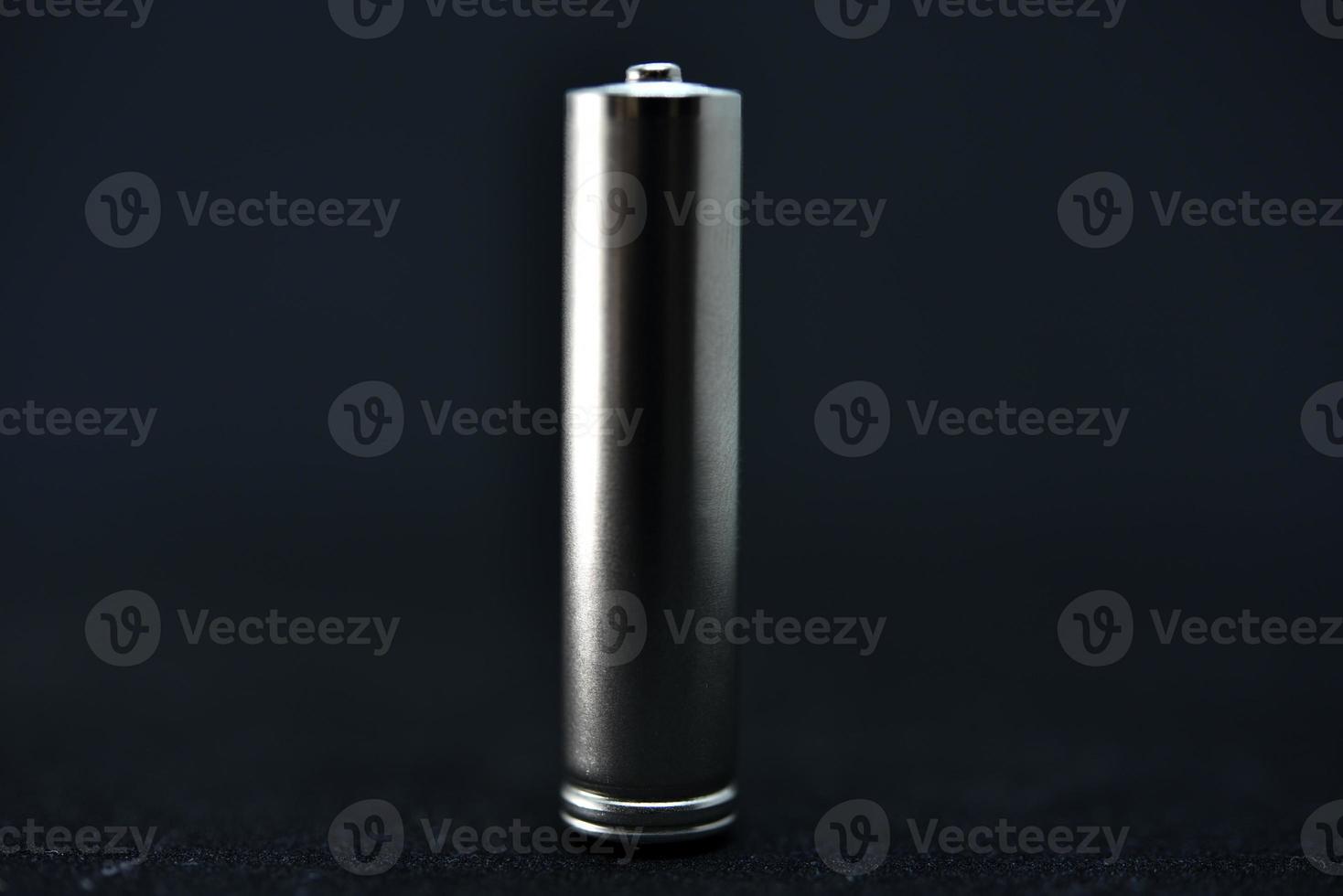 A shiny electric battery on a black background. The battery is a close-up. photo