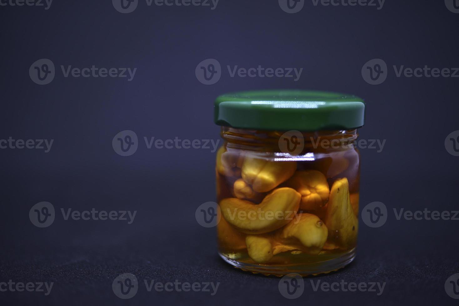Glass jars with nuts in honey. Delicious sweets. Nuts in honey. Sweet nuts. photo