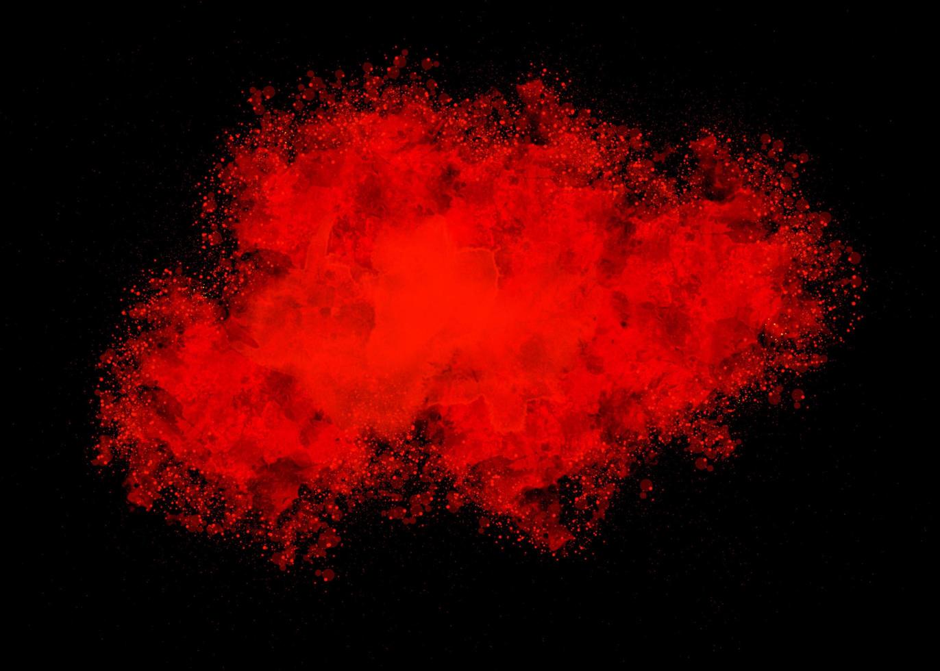 Red color dust particle explosion cloud on black background.color powder splash photo