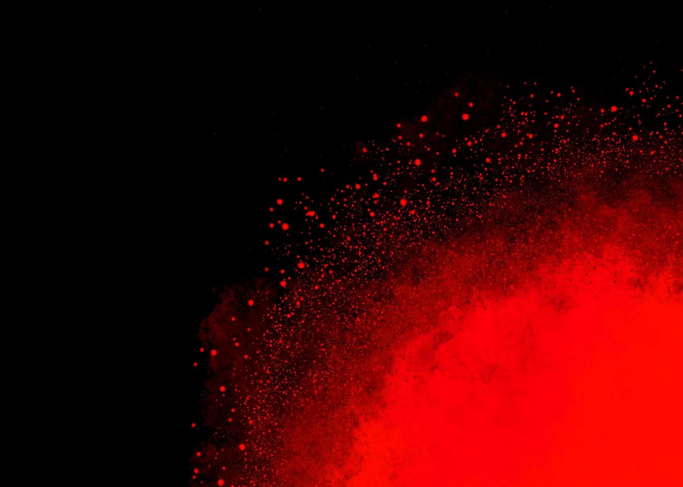 Red color dust particle explosion cloud on black background photo